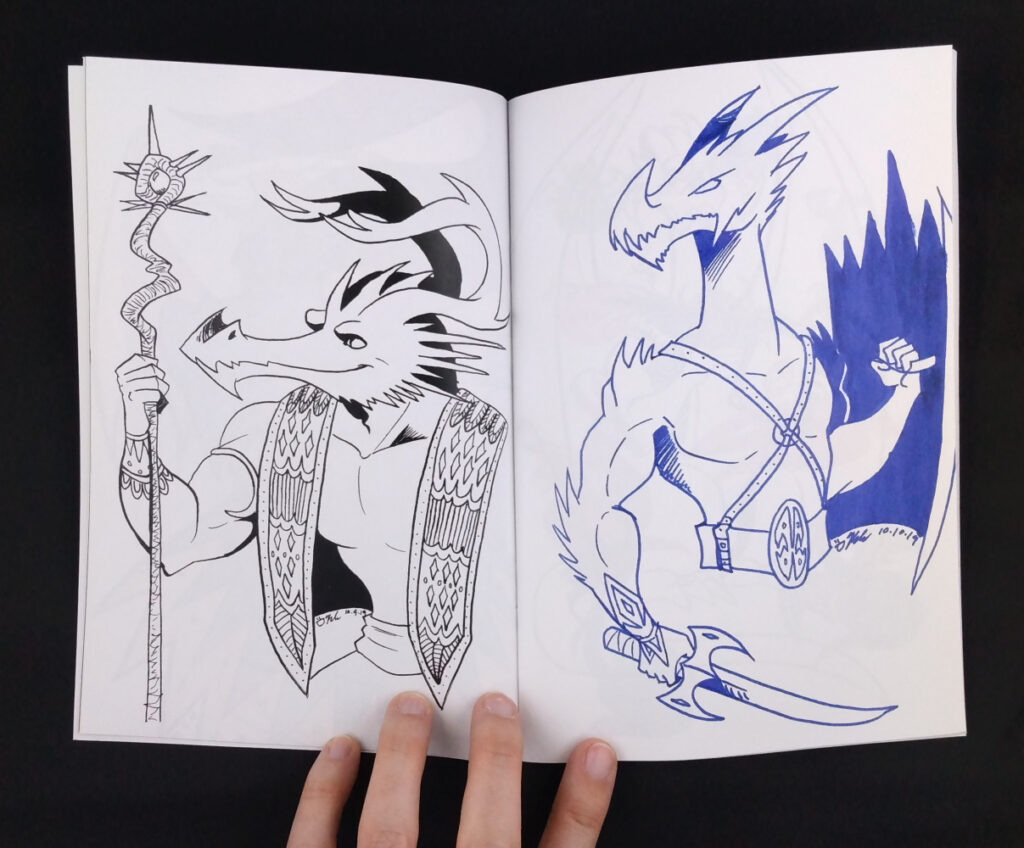 a zine opens to two illustrations. On the left is a dragon in a vest, holding a magic staff. On the right is a dragon man, wielding a dagger and shield. Fingers from a white hand hold the spread open.